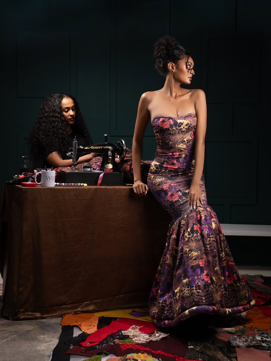 Selamawit at the sewing machine, model seated beside her